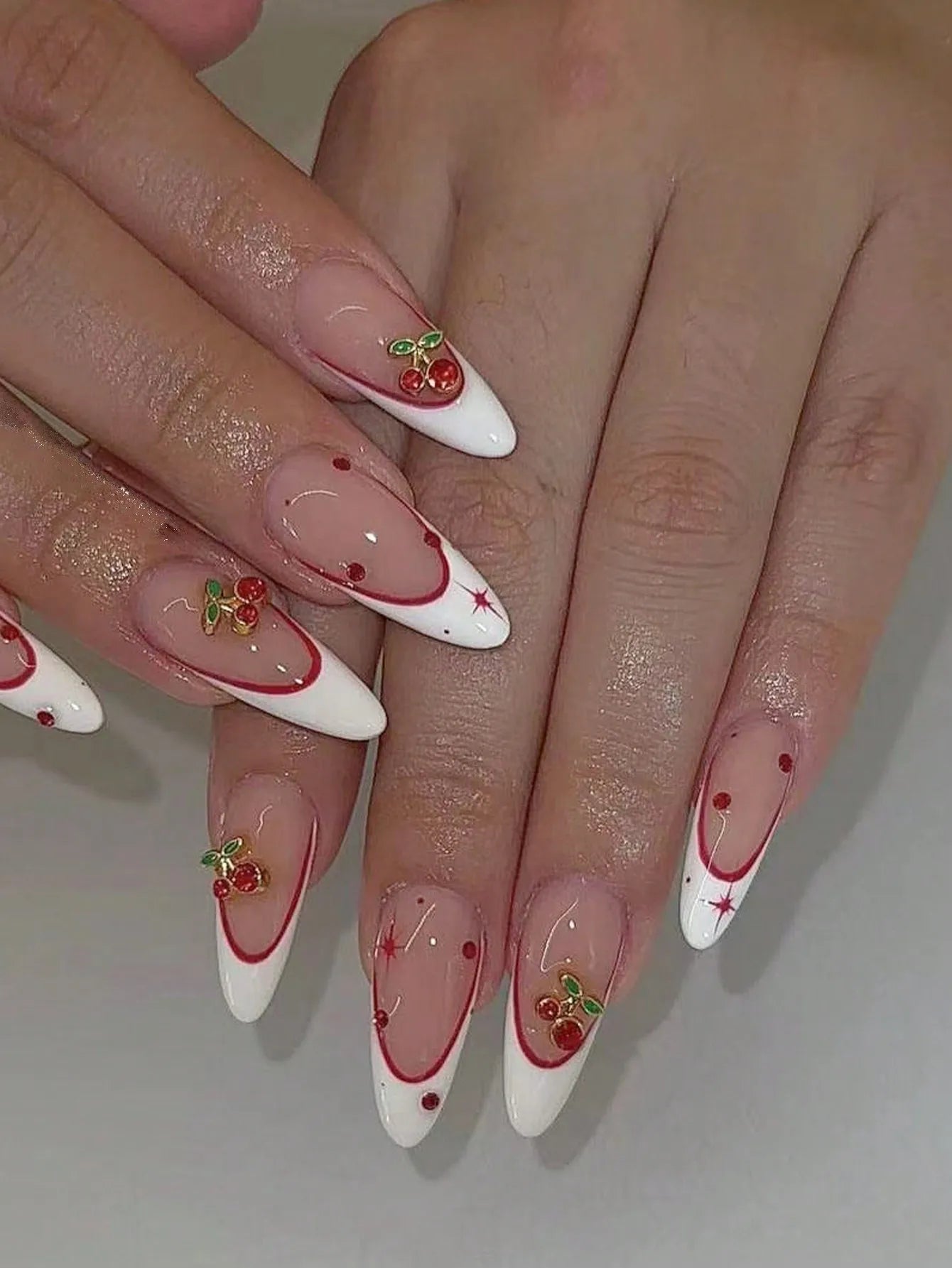 10 pieces of pure handmade almond-shaped nails, with white French tips and red cherry decorations. They are suitable for daily c