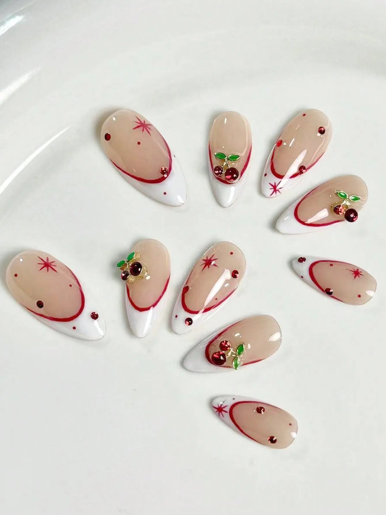 10 pieces of pure handmade almond-shaped nails, with white French tips and red cherry decorations. They are suitable for daily c