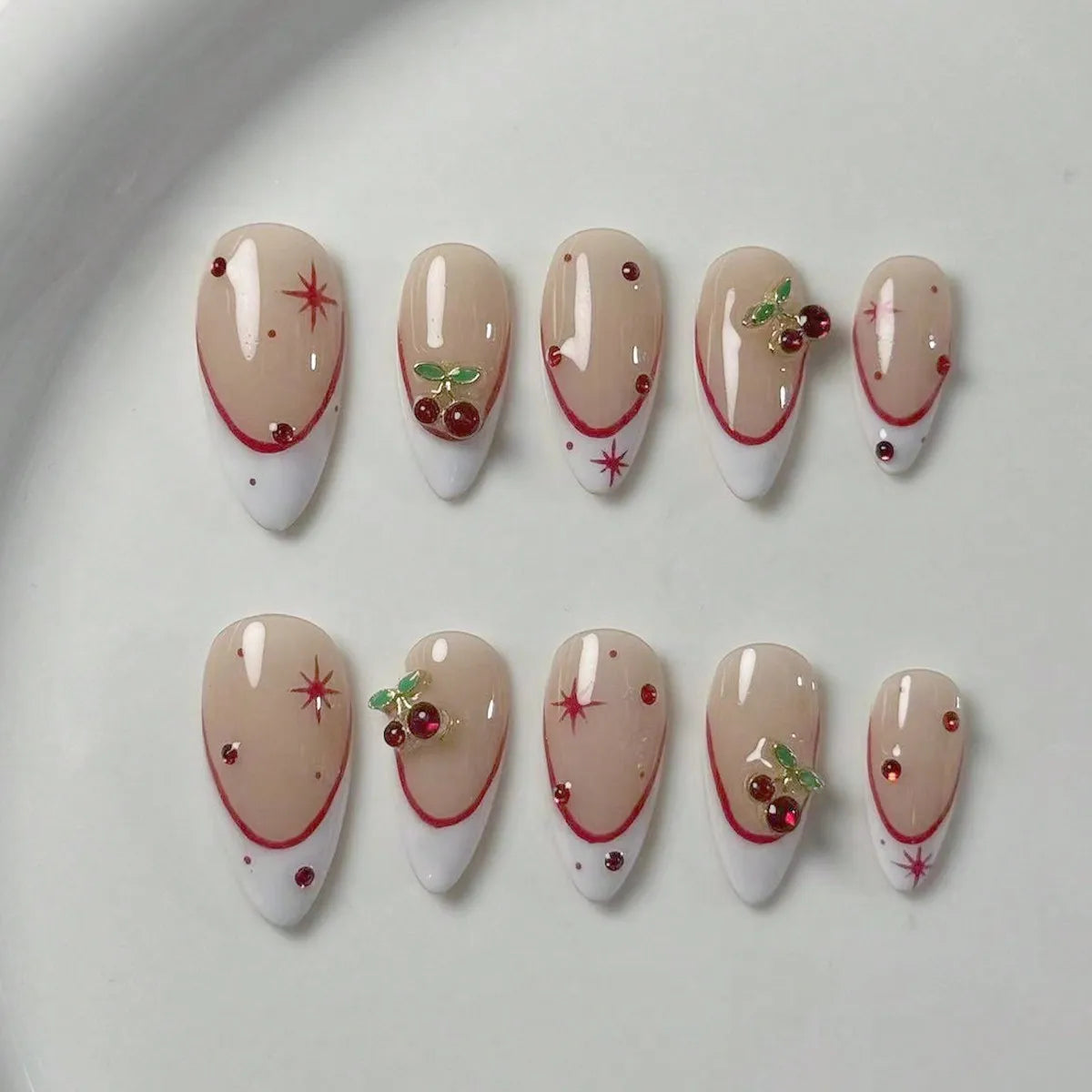 10 pieces of pure handmade almond-shaped nails, with white French tips and red cherry decorations. They are suitable for daily c